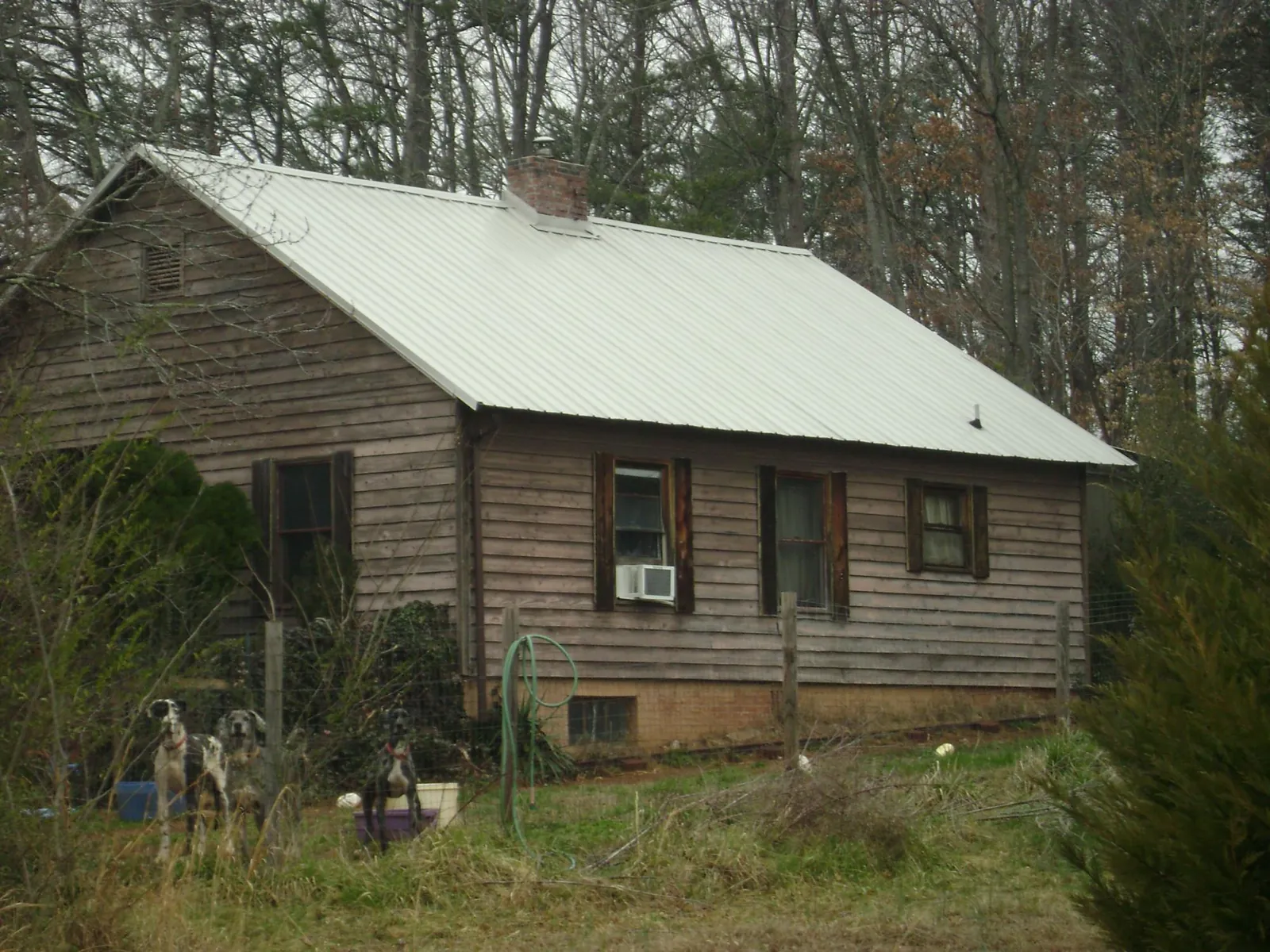White metal roof on an old wood sided farmhouse, from a Metal Roof Installation job in Simonton